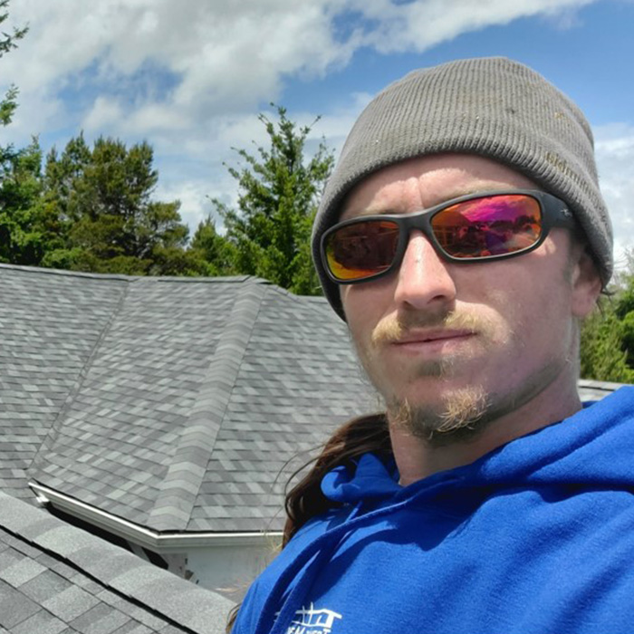 contractor selfie on top of house with asphalt shingles roof coos bay or